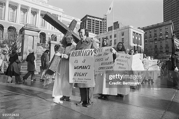 Birth Control advocate Bill Baird leads a group in front of the State House here, to protest a proposed amendment to the U.S. Constitution which...