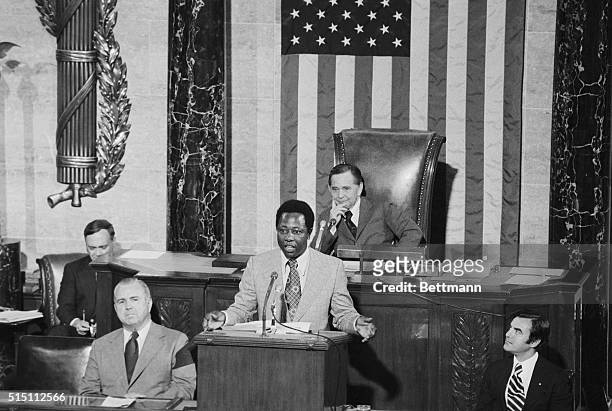 Home run King, Hank Aaron, of the Atlanta Braves, takes part in Flag Day Ceremonies on the floor of the House of Representatives. In the background...