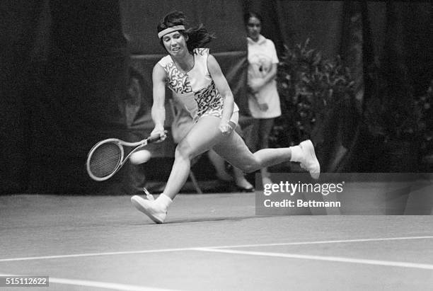 Tennis pro Rosie Casals races to reach a serve by Kerry Nelville in their match in the Virginia Slims Tennis Tournament here 4/26. Casals won in two...