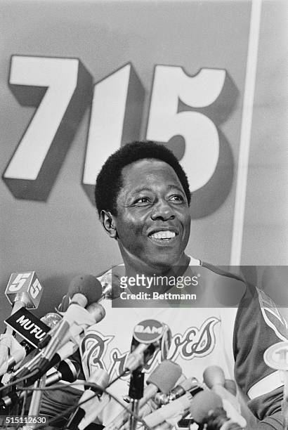 Wearing a broad smile, Hank Aaron describes his 715th home run during a news conference following the game. Aaron broke Babe Ruth's old record of 714...