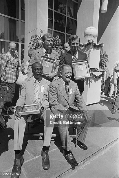 The Baseball Hall of Fame's newest members display their plaques after being inducted to the Hall. Standing left to right are Mickey Mantle and...