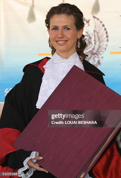Syria's First Lady Asma al-Assad poses for a photo after receiving an honorary doctorate from the Faculty of Archeology of Rome's La Sapienza...