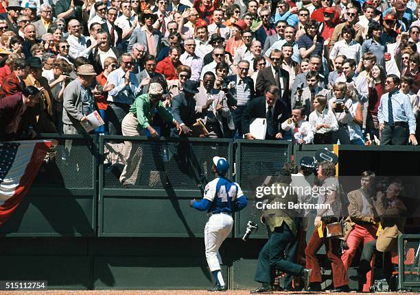 Atlanta Brave's Hank Aaron runs to his wife here, after his 714th home run, tying with Babe Ruth at the Riverfront Stadium in the game against the...