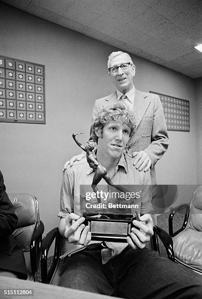 Westwood, CA.: UCLA's Bill Walton holds the Sullivan award as his coach of four years, John Wooden, beams his approval following the announcement...
