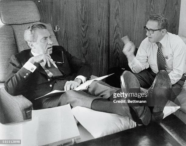 Up in the Air. Undated: President Richard Nixon and Secretary of State Henry Kissinger confer aboard Air Force One as it heads towards Brussels,...