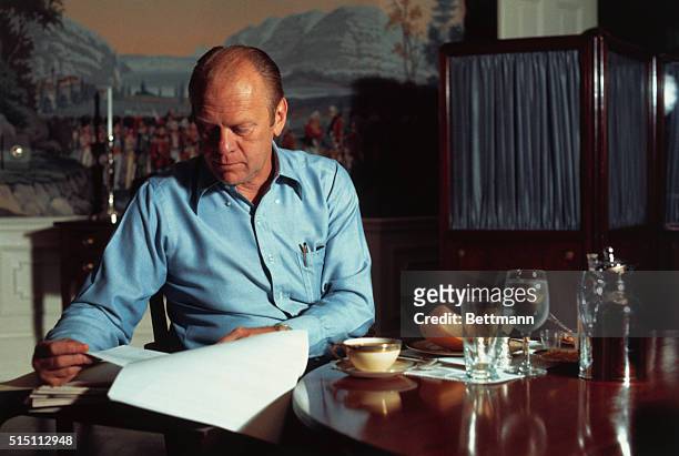 Washington, D.C.: President Gerald Ford eats breakfast he fixed for himself in the small kitchen of the living quarters in the White House. He goes...