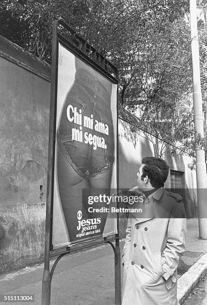 It looks pinchable, but it's not. A male passerby takes a second look at the controversial advertisement for Jesus Jeans showing the posterior of...