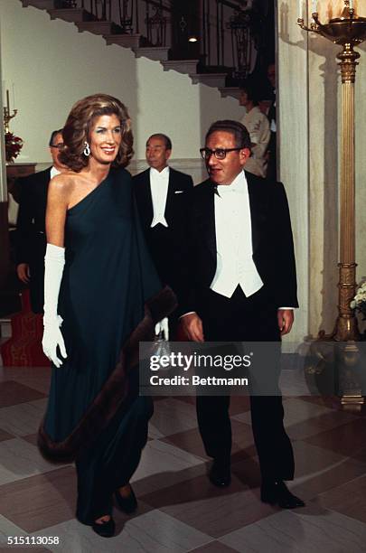 Henry A. Kissinger, Secretary of State, arriving at White House reception with wife.