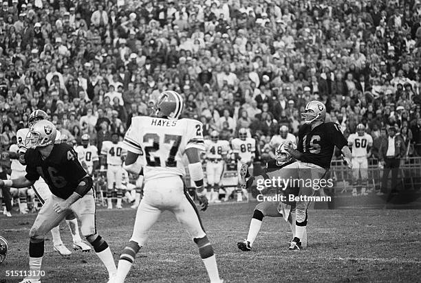 Oakland Raiders' Ken Stabler and George Blanda watch intently as Blanda kicks 36-yard field goal with two seconds remaining in overtime quarter to...