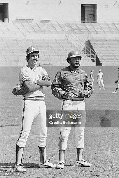 Oakland, Calif.: Oakland Athletics relief pitcher Rollie Fingers and right fielder Reggie Jackson stare intently down the field as the A's worked out...