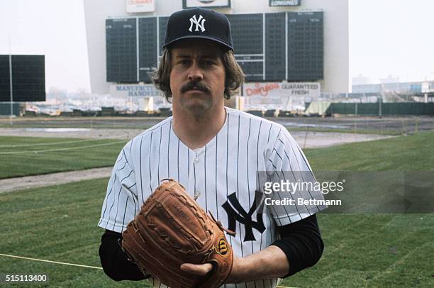New York, New York: In full Yankee uniform for the first time, Jim "Catfish" Hunter plays with a baseball during his visit to Shea Stadium which will...
