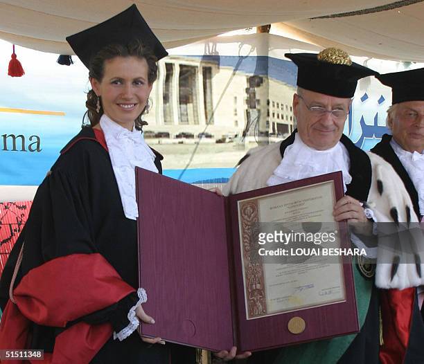 Syria's First Lady Asma al-Assad receives an honorary doctorate from Roberto Antonelli, the president of Rome's La Sapienza University, during an...