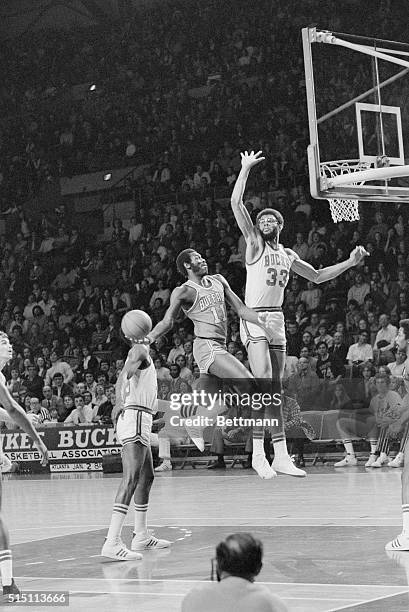 Milwaukee: Buffalo Braves Bob McAdoo tries to slip a one handed shot past Milwaukee Bucks' Kareem Abdul-Jabbar during the first half of the...