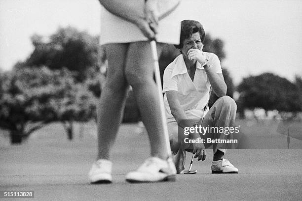 Veteran golfer Kathy Whitworth eyes the putt stroked by Sandra Post on the 15th green. Whitworth shot a one under par and Post shot even par. The two...