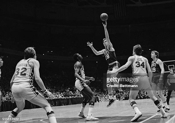 Boston Celtics' Dave Cowens goes up for basket against Philadelphia 76ers.