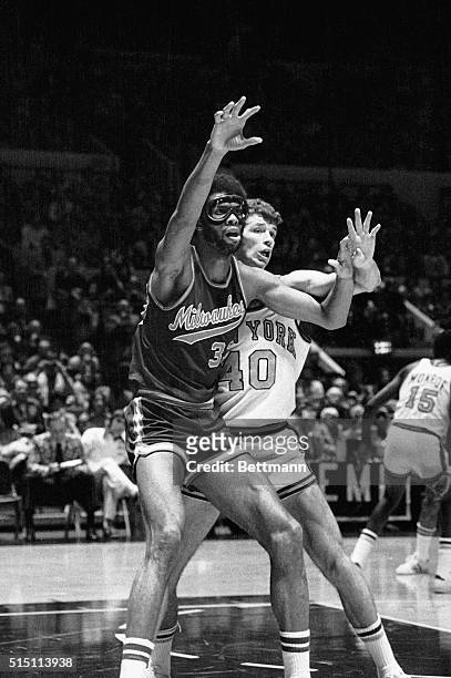 New York, NY- Kareem Abdul-Jabbar, wearing industrial safety goggles to protect his left eye, which was injured seven weks ago, is closely guarded by...