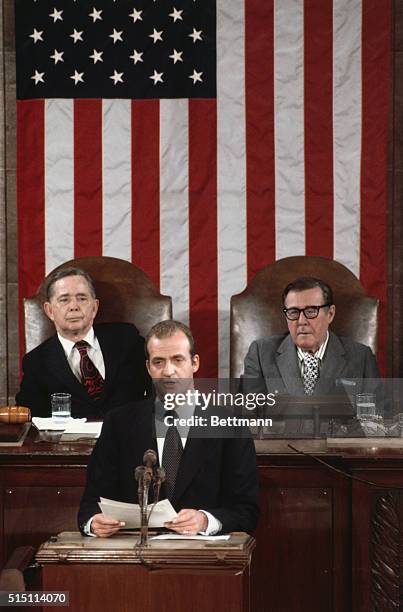 Washington: King Juan Carlos of Spain addresses a Joint Session of Congress at the Capitol. In rear are Speaker of the House Carl Albert, left, and...