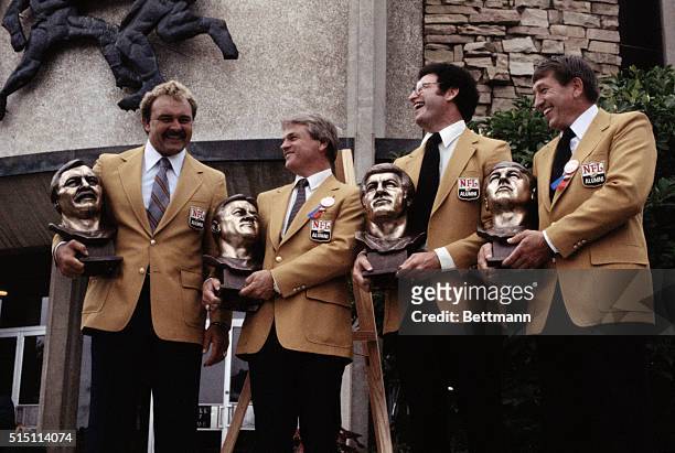 Pro football Hall of Fame inductees pose on the steps of the Hall of Fame. From left to right are Dick Butkus, Yale Lary, Ron Mix and Johnny Unitas.
