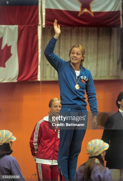 Montreal: East Germany's swimmer Kornelia Ender waves from victory stand after she won 7/22, her 4th Gold Medal for her victory in women's 200-meter...
