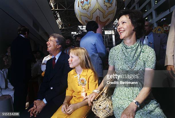 Atlanta: Jimmy Carter, Wife, and daughter Amy watch a puppet show at an Atlanta amusement complex 6/8. Primary wins push Carter close to the...