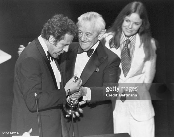 Director Milos Forman is presented his Oscar for the Best Achievement in directing by William Wyler as Diane Keaton looks on at the 48th Annual...