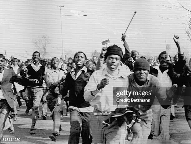 Black students protesting against the compulsory teaching of Dutch-based Afrikaans in black schools charge during a riot in Soweto. Police opened...