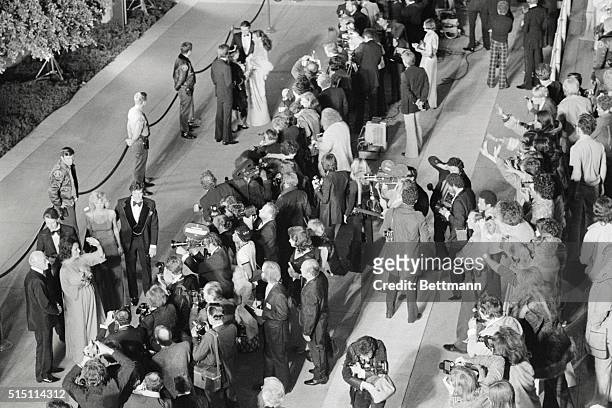 Hollywood, Los Angeles, California: Actress Elizabeth Taylor waves to the fans as she arrives for the 48th Annual Academy Awards ceremonies at the...