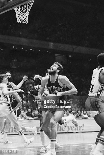 New York Knicks forward Phil Jackson is fouled by Sixers forward Joe Bryant while driving to the basket during a game at the Spectrum Sports Arena in...