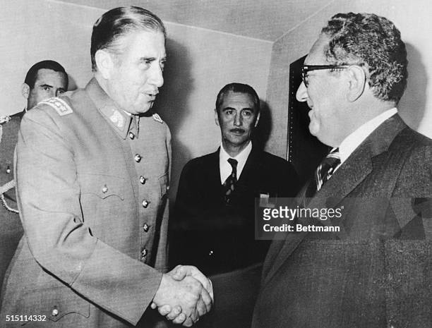 Chilean President Augusto Pinochet greets Secretary of State Harry Kissinger on his arrival at the President's office. Kissinger took up the issue of...