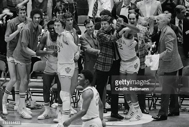 Philadelphia: Indiana's head coach, Bobby Knight hugs Scott May as they are jubliant after defeating Michigan to win the NCAA basketball championship...