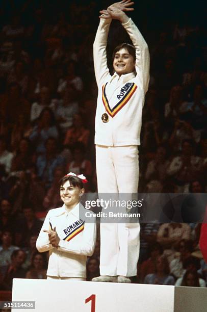 Montreal, Canada: Romanian gymnast Nadia Comaneci is shown waving from the first place position on the winner's podium after she had won gold at the...