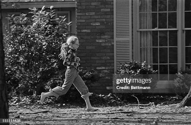 Amy Carter, President Jimmy Carter's Daughter, enjoys a barefoot romp in front of the Carter home in Plains December 25th. After a day full of family...