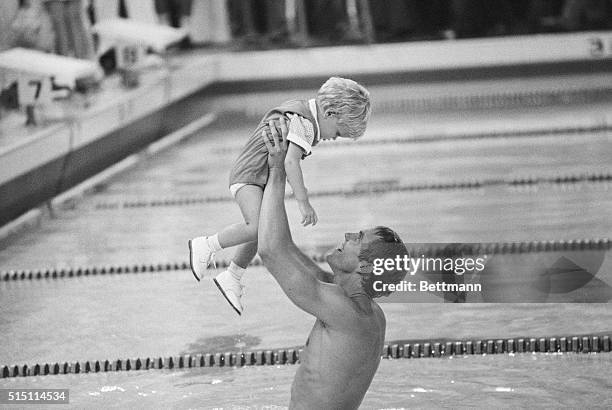 Long Beach, Calif.: Olympic swimmer Gary Hall lifts his 20-month-old son Gary Jr. Into the air after he finished second in the men's 100-meter...