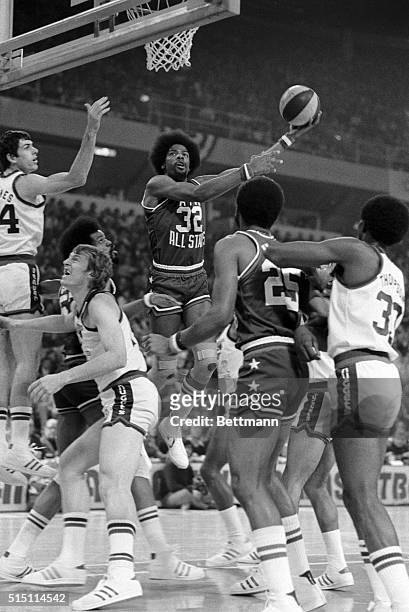 All Star Julius Erving takes a first period jump shot for two points during the 1st period of the ABA All Star game here 1/27. Also pictured, are;...