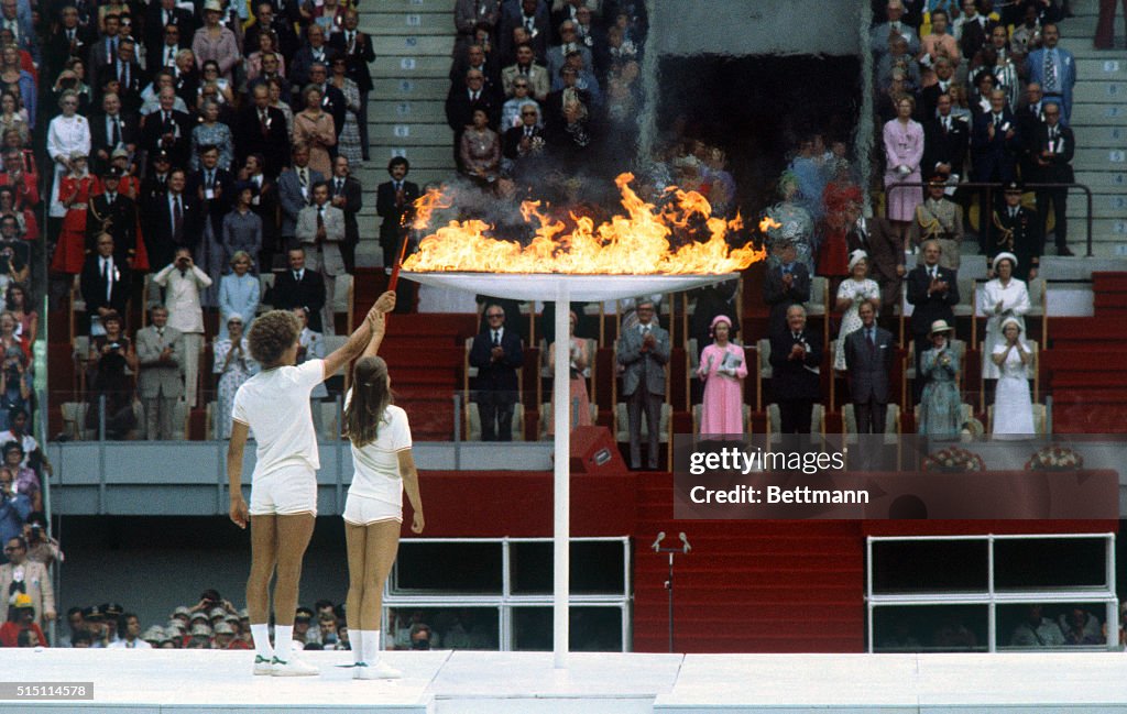 Teenagers Lighting Olympic Flame