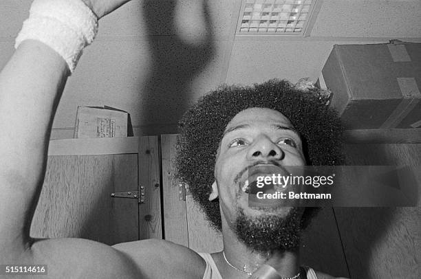 Uniondale, New York: Julius Erving of the New York Nets shouts "we're number one" in dressing room after he helped the Nets win their second ABA...