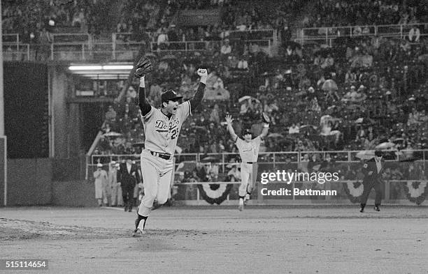 Philadelphia: Dodger pitcher Tommy John, , and first baseman Steve Garvey let out yells after defeating Philadelphia 4-1 for the National League...