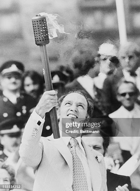 Ottawa, Ontario, Canada: Prime Minister Trudeau holds Olympic flame aloft during ceremony on Parliament Hill when the Olympic flame was lit by a...