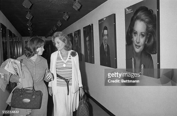 Barbara Walters passes a portrait of herself as she leaves the NBC studio, accompanied by her assistant Mary Hornickle, after her April 23, 1976 NBC...