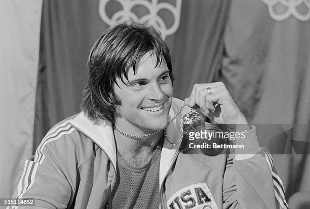 S Bruce Jenner, San Jose, CA., displays the gold medal he won in the Olympic decathlon here 7/30.