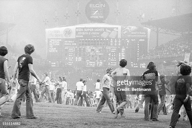 Thousands of spectators pour onto the playing field here at Comiskey Park during an "Anti-Disco" demonstration. The situation developed after a...