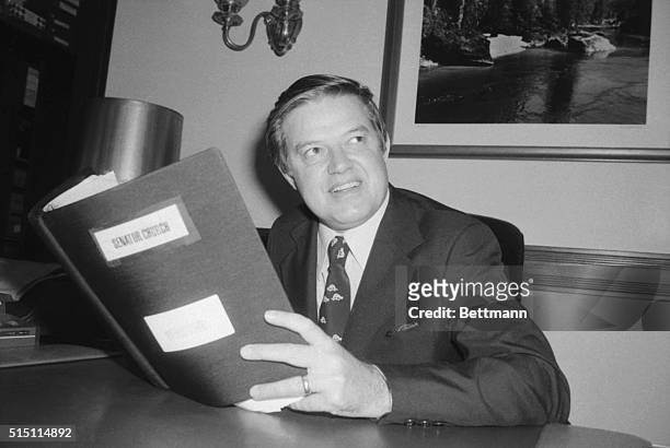Senator Frank Church , chairman of the Senate Intelligence Committee, holds his copy of a report the committee will release on April 26th on U.S....