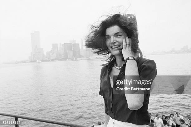 The familiar towers of lower Manhattan and the not-unknown physiognomy of Jacqueline Kennedy Onassis can be made out in New York Harbor as she...