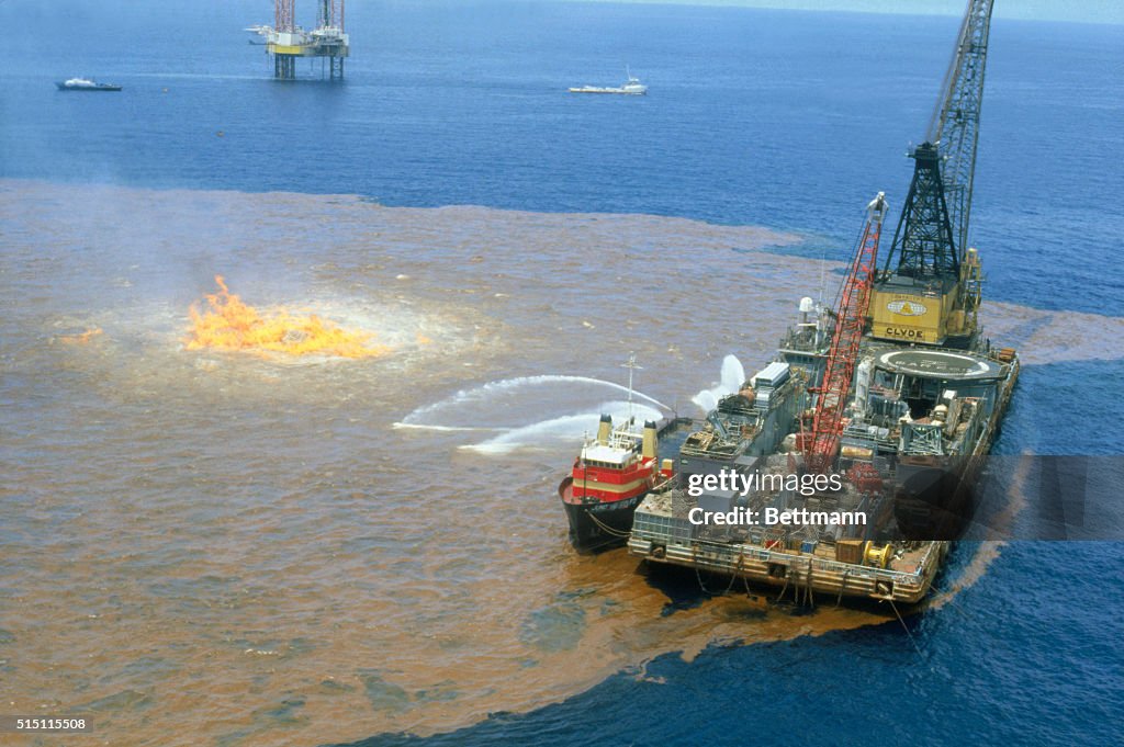 Spewing Oil Rigs Workers on barge spray chemical dispersant on excess oil around... News ...