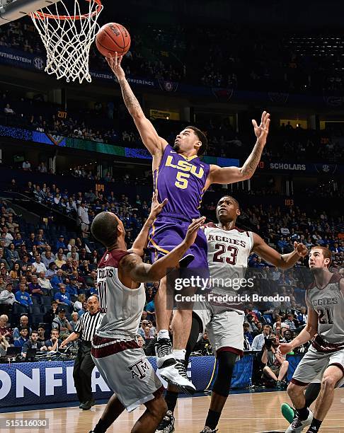 Josh Gray of the LSU Tigers takes a shot over Anthony Collins and Danuel House of the Texas A&M Aggies during the first half of an SEC Basketball...