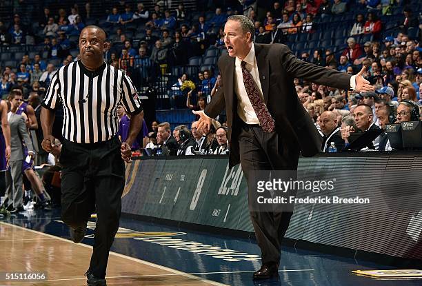 Head coach Billy Kennedy of the Texas A&M Aggies pleads with an official during the first half of an SEC Basketball Tournament Semifinals game...