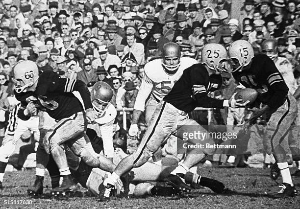 Iowa's Randy Duncan handed off to back Willie Fleming who circled left end behind guard Hugh Drake for short yardage in the second period against...