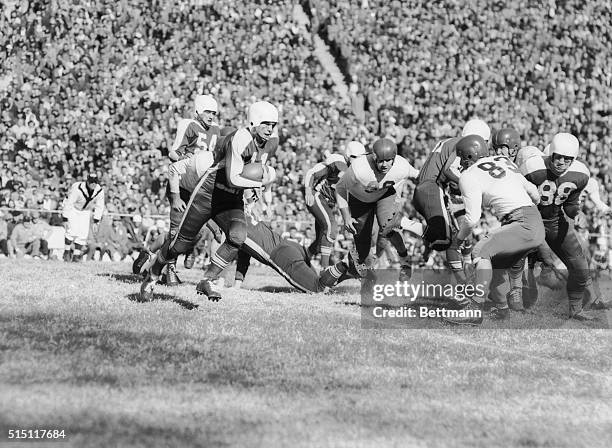 Lamar McHan, Arkansas halfback, skirts right end of SMU line to pick up 11 yards before being stopped by Harry Dean of SMU. Pat Summerall of Arkansas...