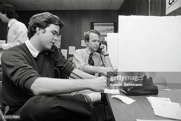 Des Moines, Ia.: Sons of presidential candidate George Bush help man the phones at the Bush phone bank headquarters. Jeb and Neil Bush make last...