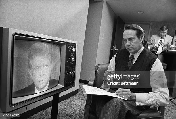 Des Moines: Republican presidential candidate Sen. Robert Dole takes notes as he watches President Jimmy Carter address the nation on the Soviet...